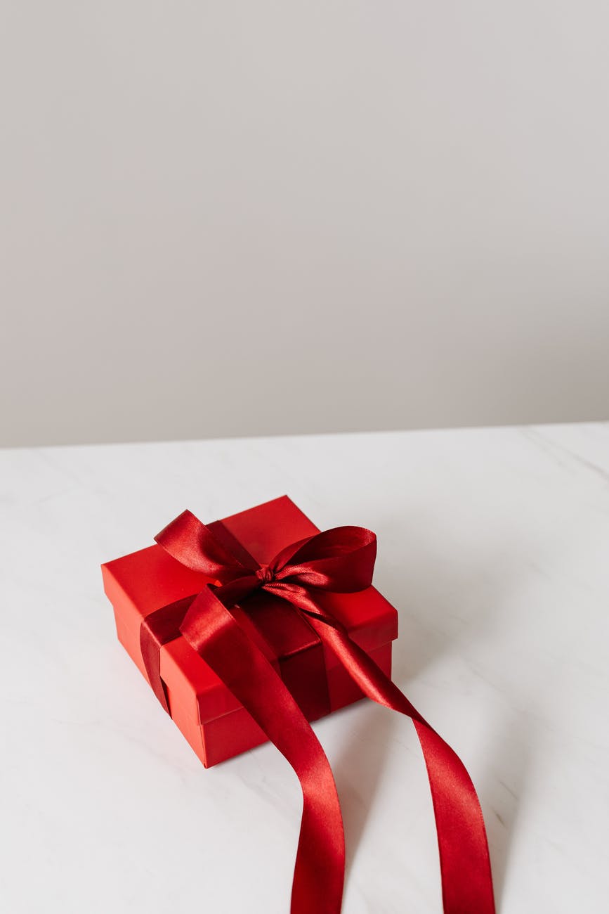 red gift box with ribbon on table